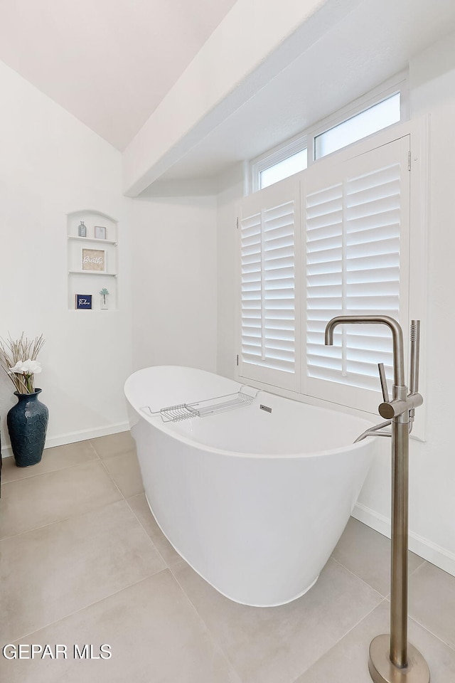 bathroom featuring tile patterned floors and a tub to relax in