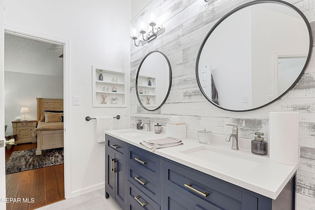 bathroom featuring vanity, a textured ceiling, and wooden walls