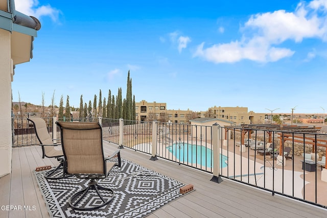 wooden terrace featuring a fenced in pool