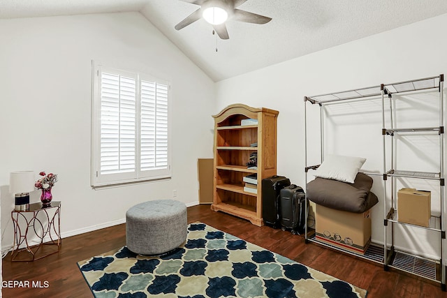 sitting room featuring vaulted ceiling, ceiling fan, and dark wood-type flooring