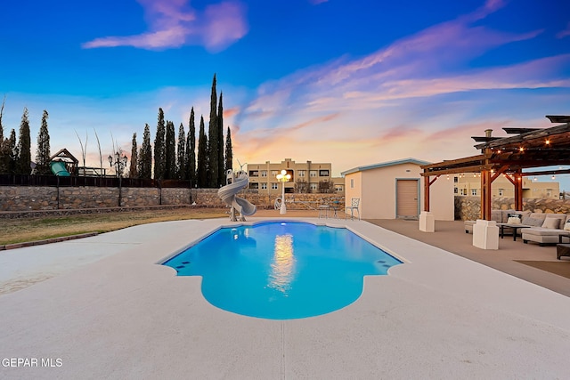 pool at dusk with an outdoor living space, a patio, a pergola, and a water slide