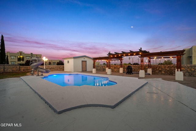 pool at dusk with an outdoor structure, a pergola, a patio, and a water slide