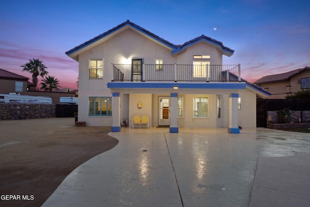 view of front of house featuring a balcony