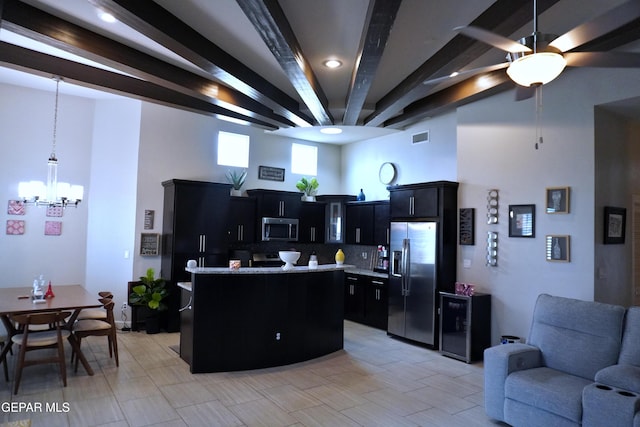 kitchen with pendant lighting, a center island, backsplash, appliances with stainless steel finishes, and beamed ceiling