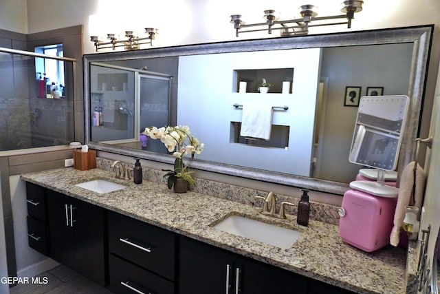 bathroom featuring vanity and an enclosed shower