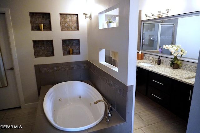 bathroom with tile patterned floors, plus walk in shower, and vanity