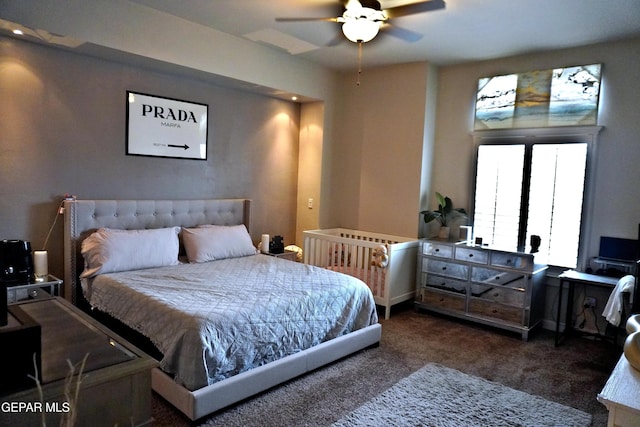 bedroom with ceiling fan and dark colored carpet