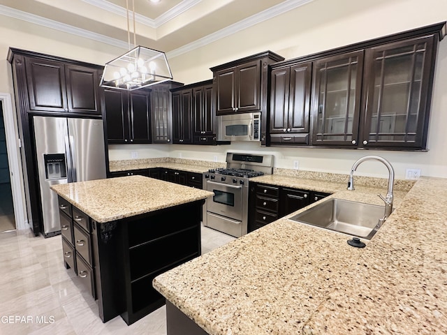 kitchen featuring sink, hanging light fixtures, light stone counters, dark brown cabinets, and appliances with stainless steel finishes