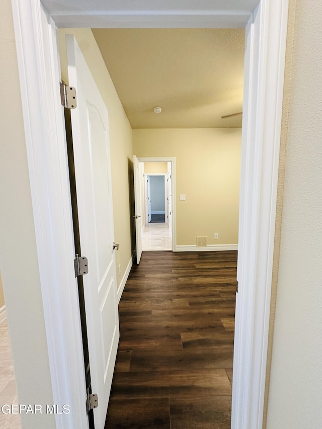 corridor with dark wood-type flooring