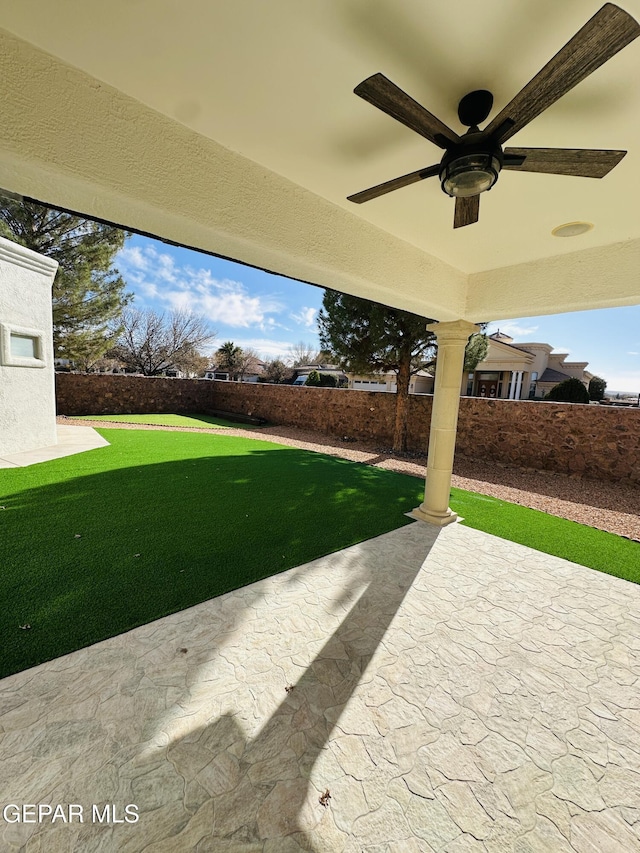 view of yard featuring a patio area and ceiling fan