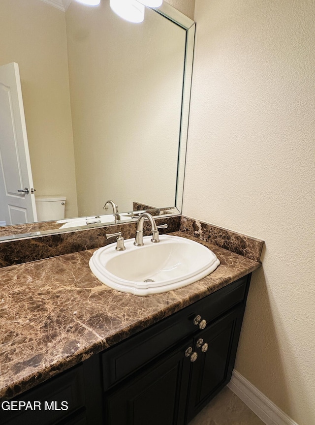 bathroom featuring vanity and toilet