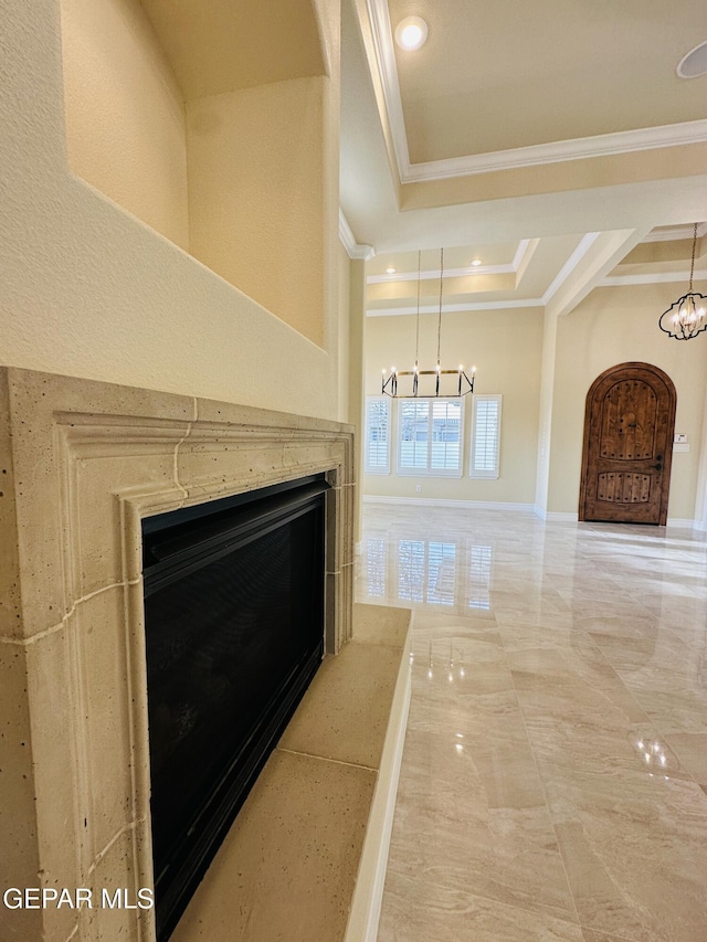 corridor with an inviting chandelier and ornamental molding