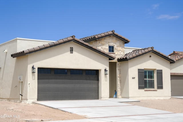 mediterranean / spanish-style home featuring a garage