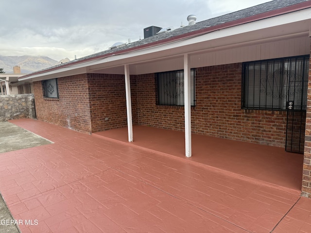 view of patio / terrace with a mountain view and central air condition unit