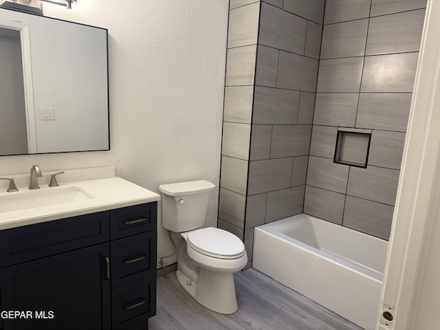 bathroom with shower / bathtub combination, vanity, toilet, and wood finished floors