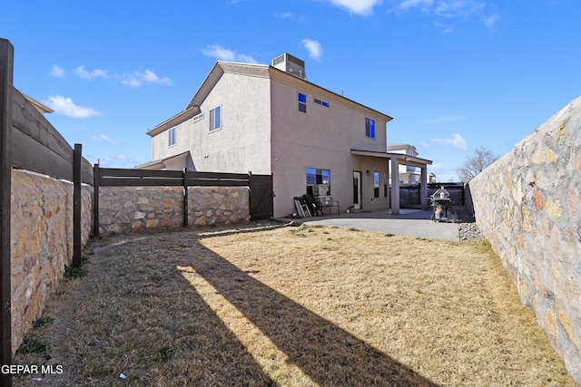 rear view of property featuring a patio area