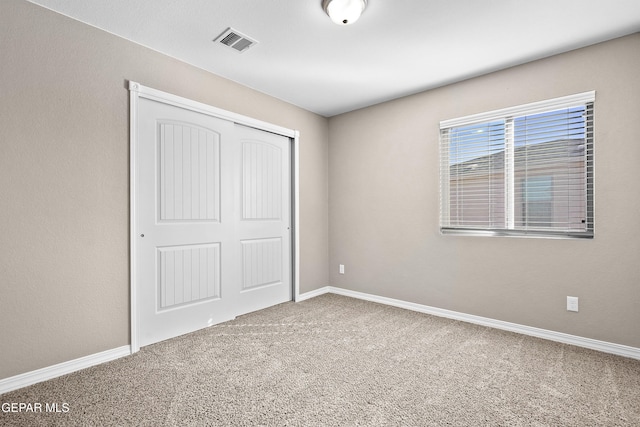 unfurnished bedroom featuring a closet and carpet floors