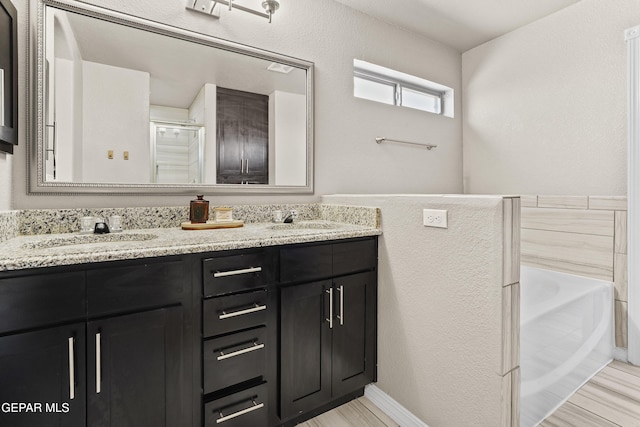 bathroom with vanity, wood-type flooring, and shower with separate bathtub