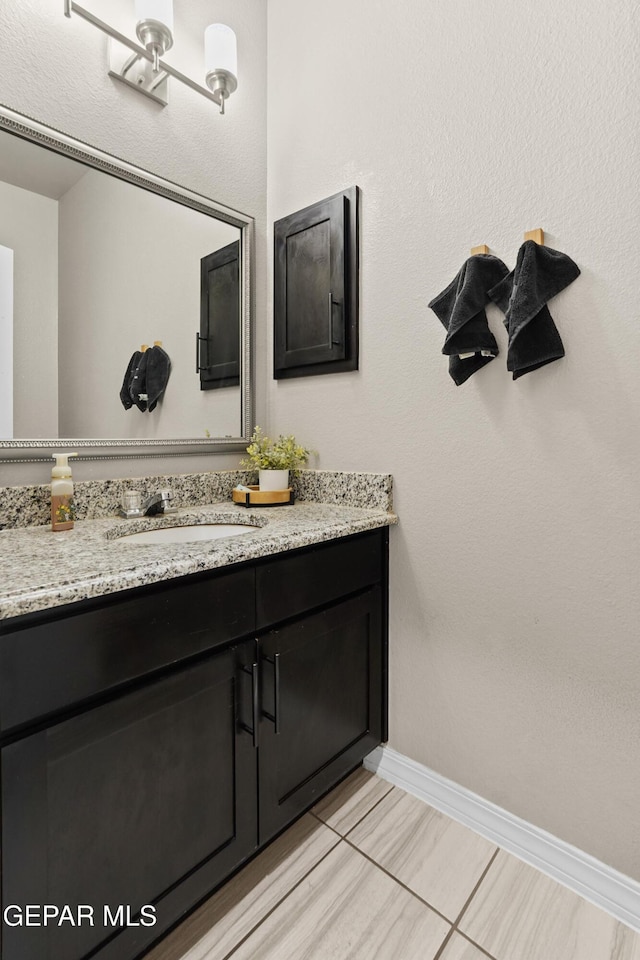 bathroom with tile patterned flooring and vanity