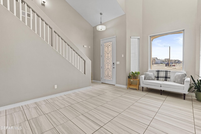 tiled foyer entrance with a towering ceiling