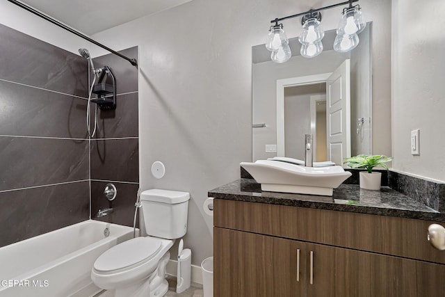 full bathroom featuring vanity, toilet, and tiled shower / bath