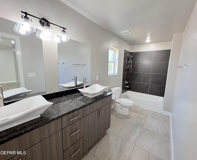 full bathroom with vanity, toilet, and tiled shower / bath combo