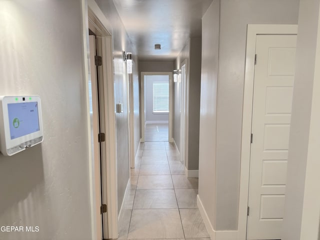 hall with light tile patterned floors