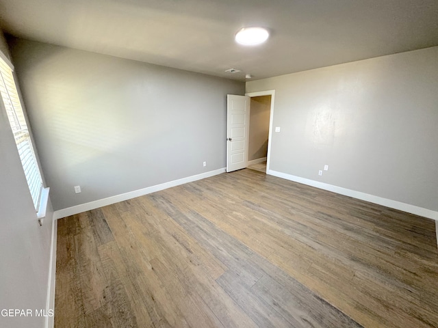 unfurnished room with hardwood / wood-style floors and plenty of natural light