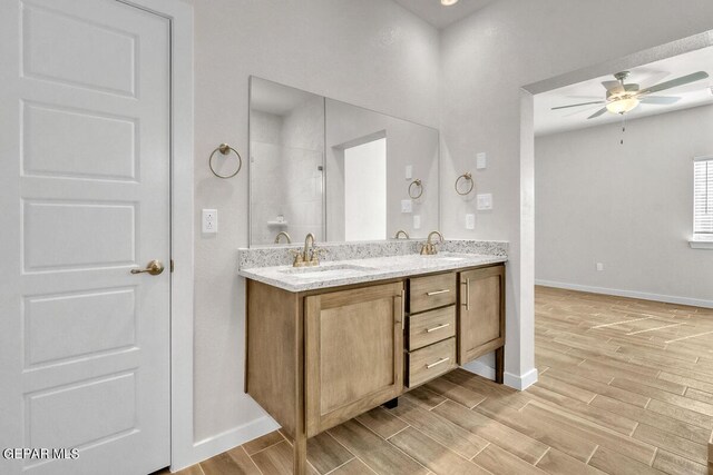 bathroom featuring a shower, ceiling fan, and vanity