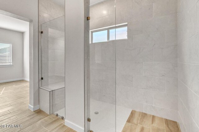 bathroom featuring walk in shower and a healthy amount of sunlight