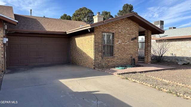 view of front of house with central AC unit and a garage