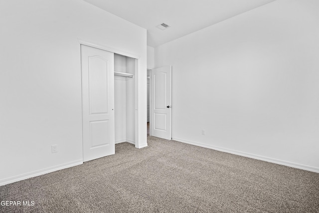 unfurnished bedroom with carpet and a closet