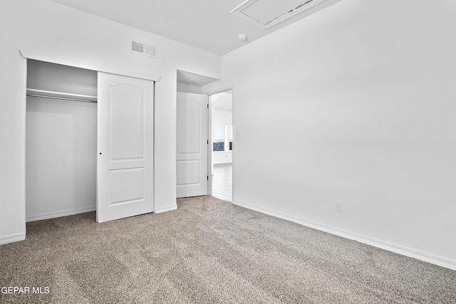 unfurnished bedroom featuring carpet floors and a closet