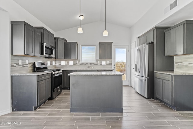 kitchen with gray cabinetry, sink, hanging light fixtures, and appliances with stainless steel finishes