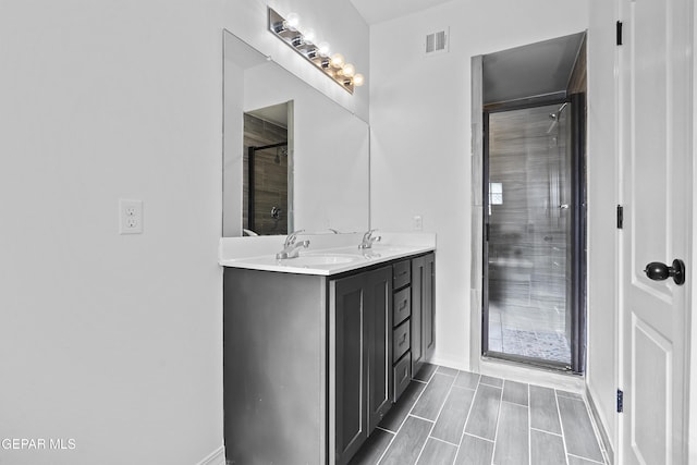 bathroom featuring a shower and vanity