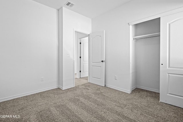 unfurnished bedroom featuring a closet and carpet floors