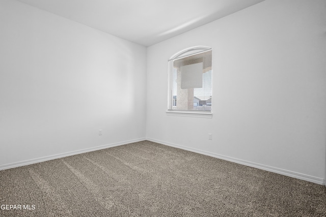 unfurnished room featuring carpet