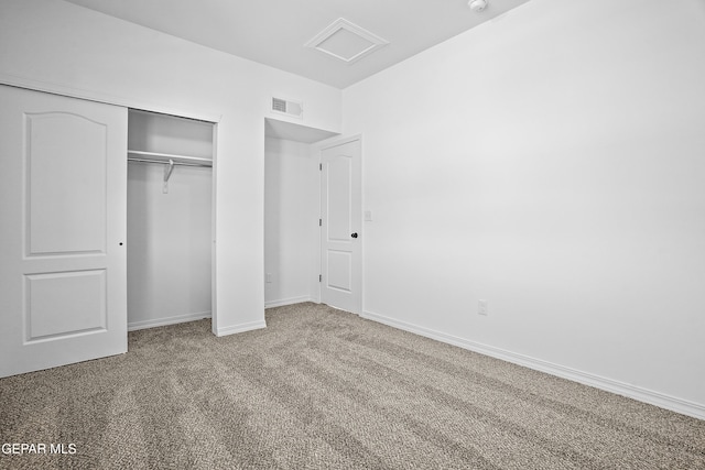 unfurnished bedroom with carpet floors and a closet