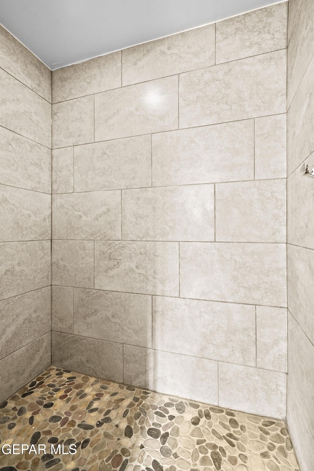 bathroom with tiled shower