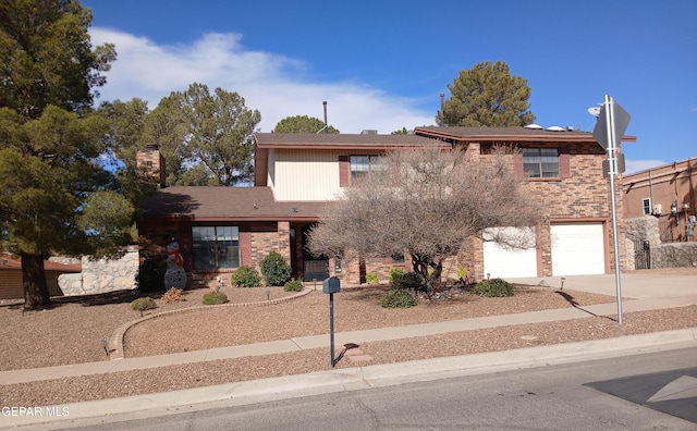 view of front of house featuring an attached garage, brick siding, and driveway