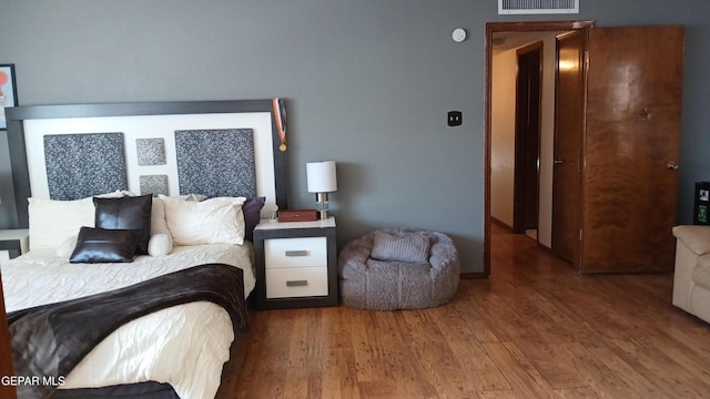 bedroom with hardwood / wood-style floors