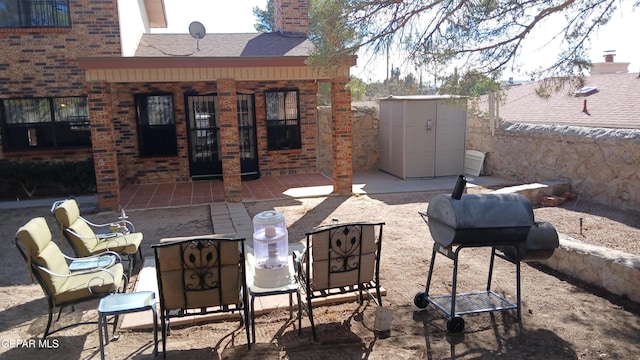 view of patio with a shed and grilling area