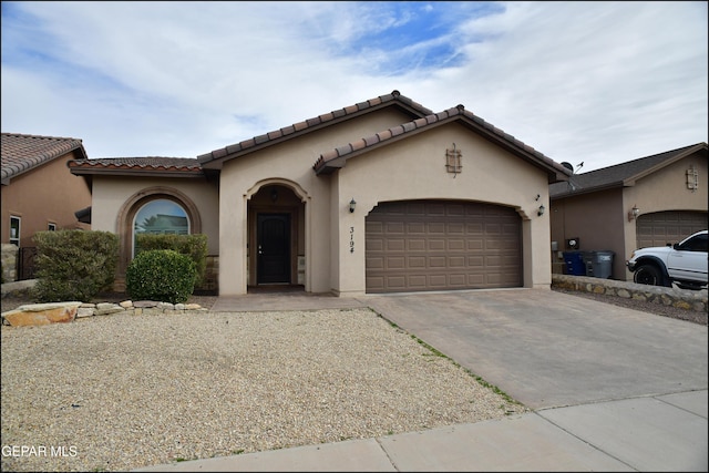 mediterranean / spanish home featuring a garage