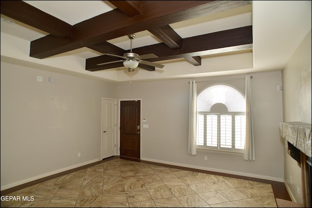 unfurnished room with ceiling fan and coffered ceiling