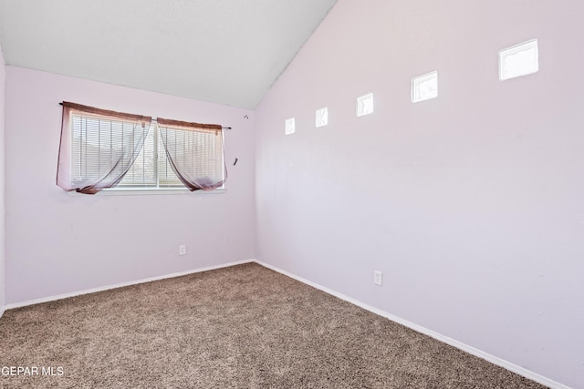 spare room featuring carpet and high vaulted ceiling