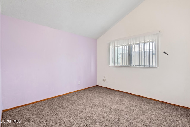 carpeted spare room featuring lofted ceiling