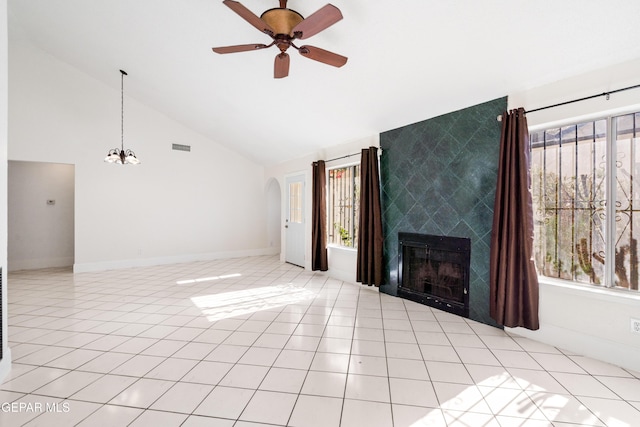 unfurnished living room with a tile fireplace, light tile patterned floors, ceiling fan with notable chandelier, and high vaulted ceiling