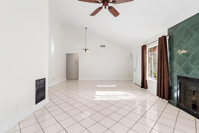 unfurnished living room with a tile fireplace, vaulted ceiling, ceiling fan, and light tile patterned flooring