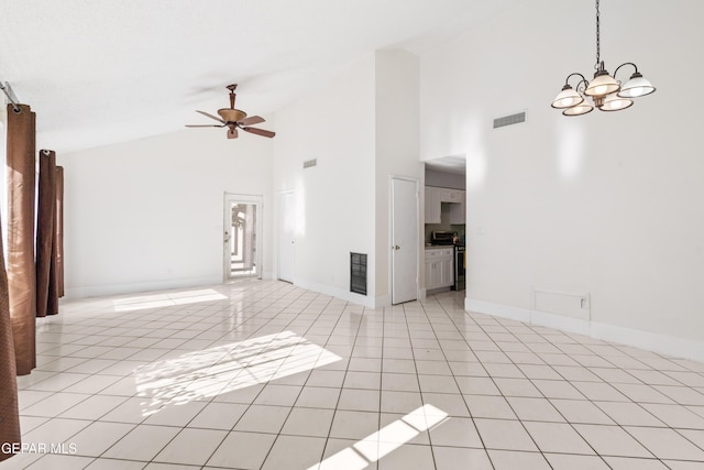 unfurnished living room with light tile patterned floors, ceiling fan with notable chandelier, and high vaulted ceiling