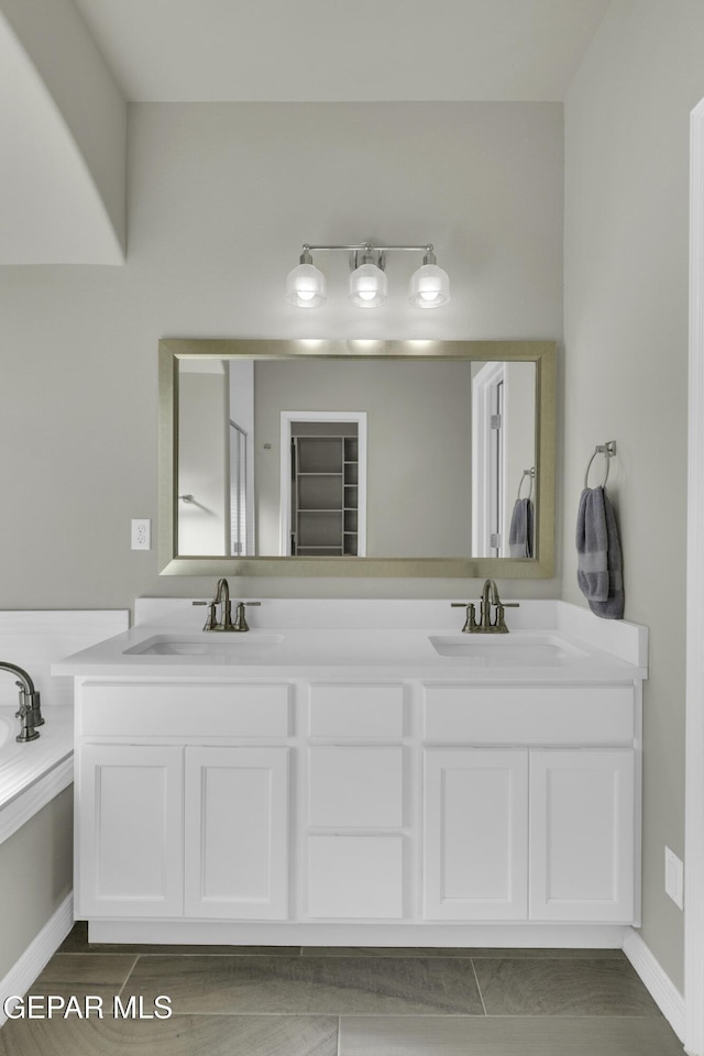 bathroom featuring a washtub and vanity